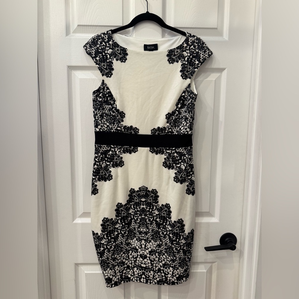 Modest white mini dress with black lace details